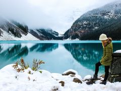 Woman at snowy Canadian lake landscape